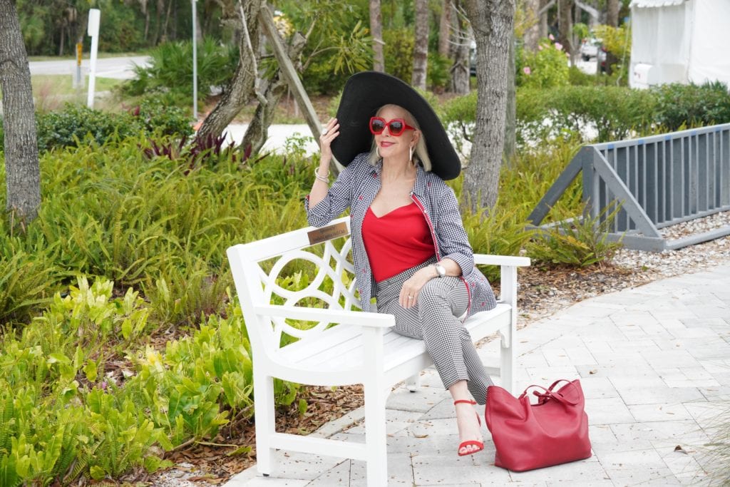 black and white 2 piece gingham pants and top with red camilsole, wide brimmed hat, red leather tote bag