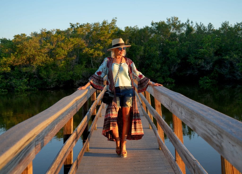 blue camisole, denim shorts with boho kimono, and hat with espadrilles