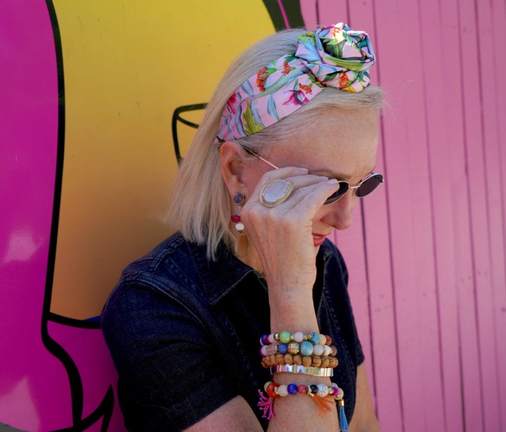 Sheree of the SheSheShow wearing wide floral headband small oval sunglasses