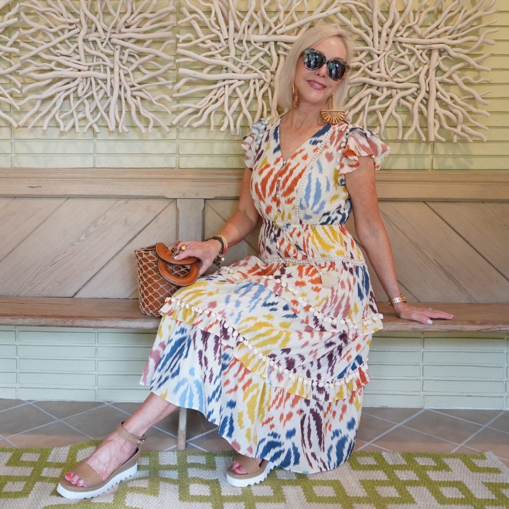 Sheree Frede of the SheShe Show wearing a colorful print summer dress