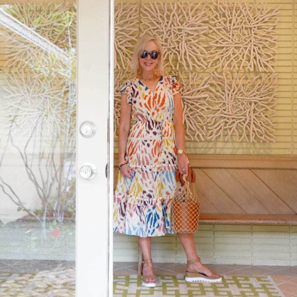 Sheree Frede of the SheShe Show wearing a colorful print summer dress