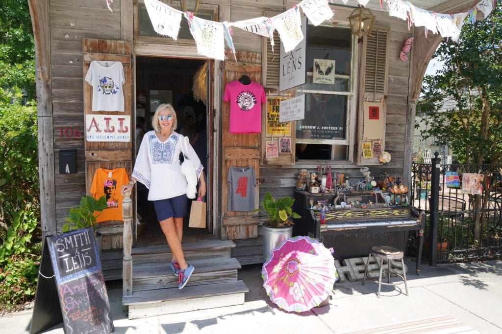 Sheree standing in front of old building with antiques on front porch