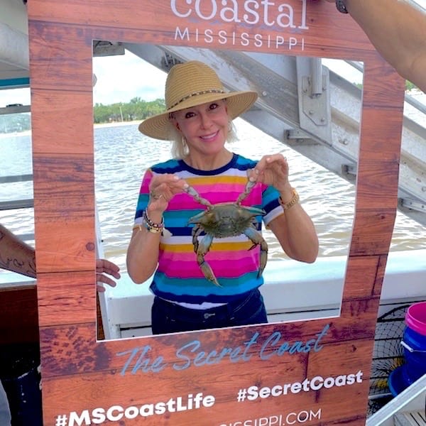 SheShe of the SheShe Show holding a live crab