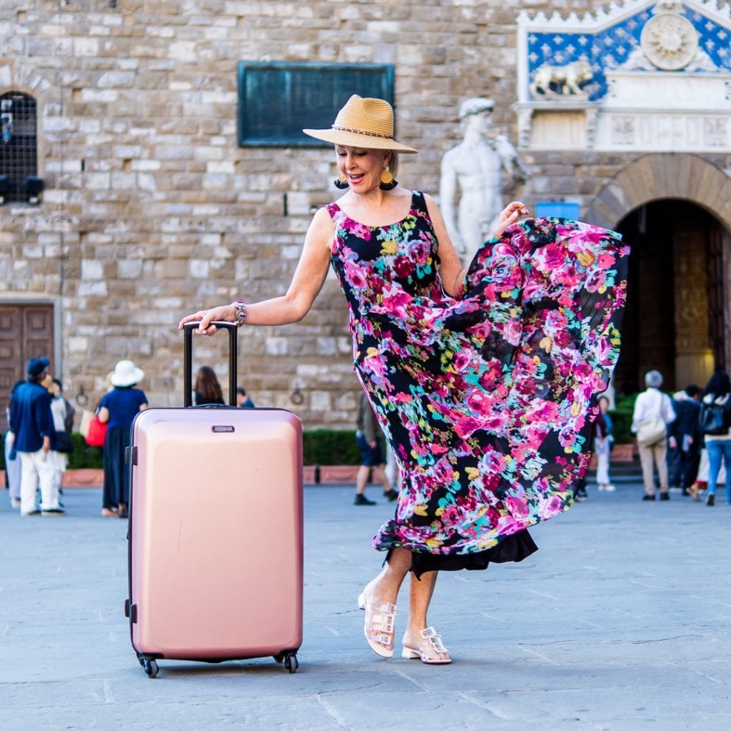 Sheree Frede of the SheSheShow with her metallic rose American Tourister bag in Florence piazza