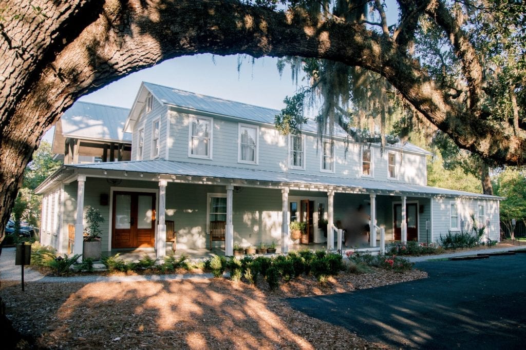 2 story house, big front porch, big overhaning tree