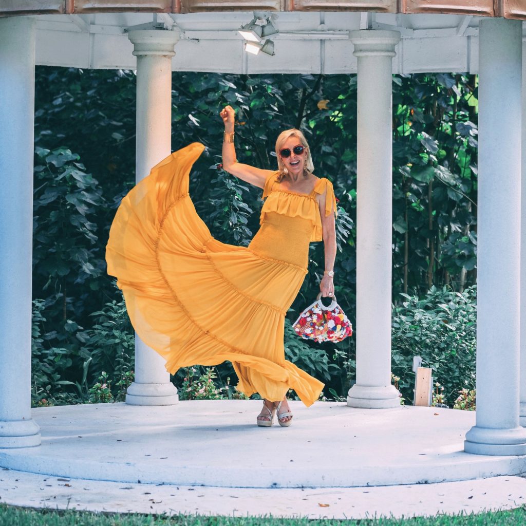 Sheree of the SheShe Show wearing a yellow maxi dress