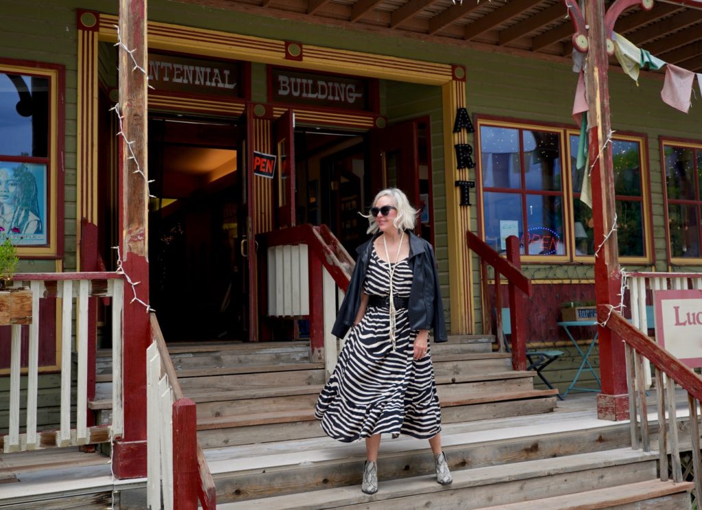 SheShe of the SheShe Show wearing zebra print maxi dress with leather bomber jacket in old western downtown