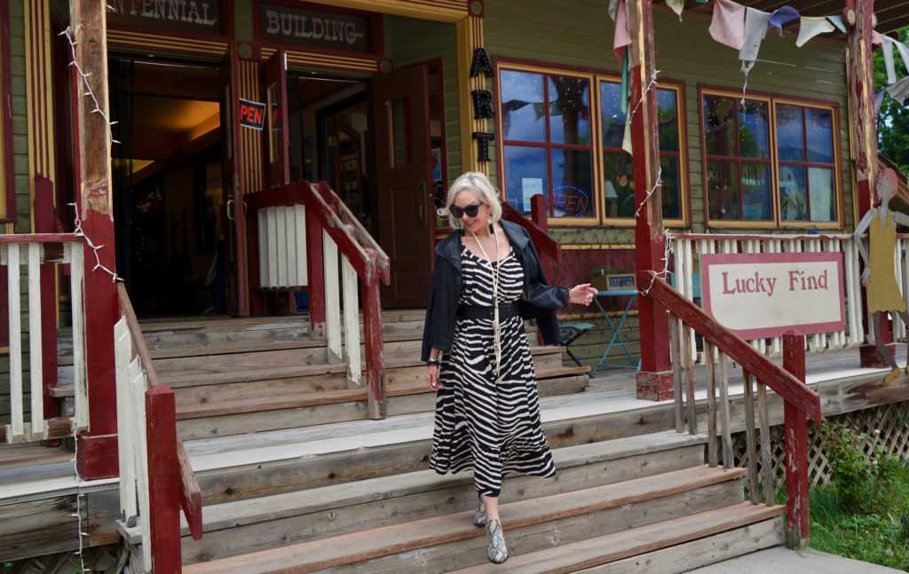 SheShe of the SheShe Show wearing zebra print maxi dress with leather bomber jacket in old western downtown