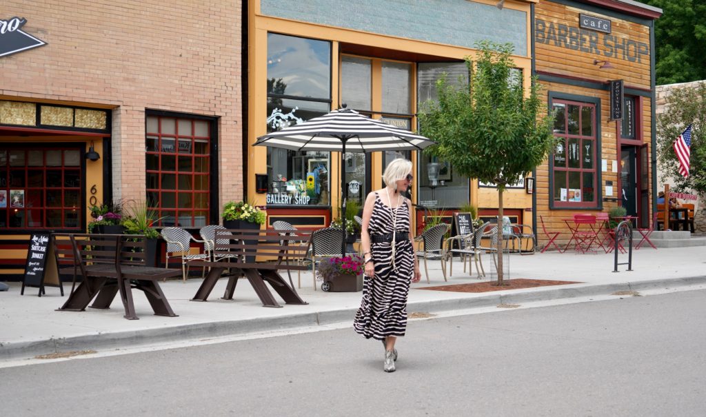 SheShe of the SheShe Show wearing zebra print maxi dress with leather bomber jacket in old western downtown