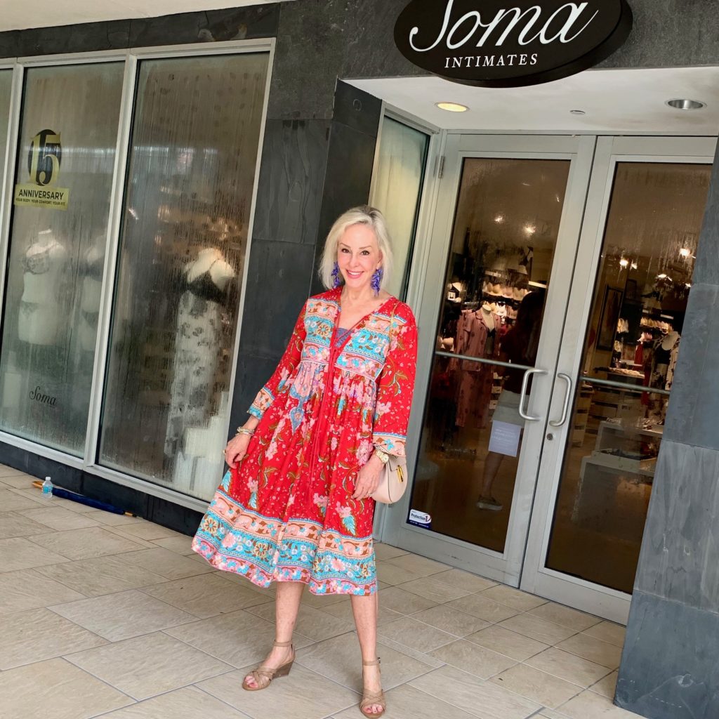 Sheree of the SheShe show wearing red print dress