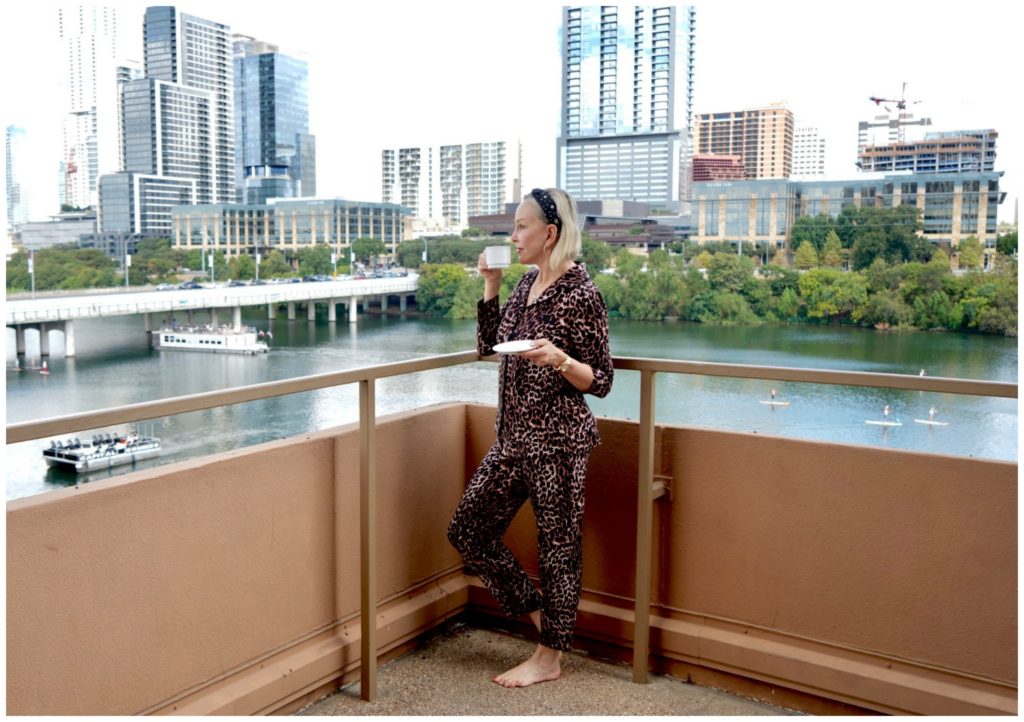 SheShe of the SheShe Show wearing leopard pj's on lake balcony in Austin