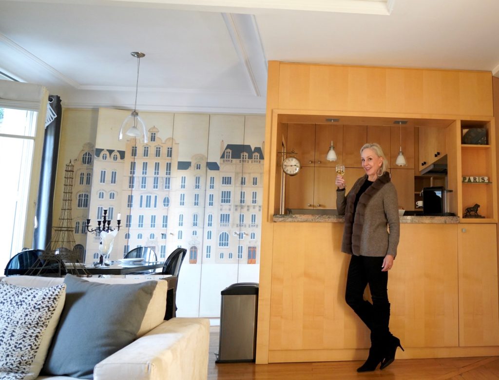 Sheree Frede of the SheShe Show standing at kitchen bar in kitchen and dining room