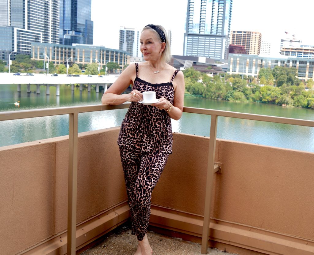 SheShe of the SheShe Show wearing leopard pj's on lake balcony in Austin