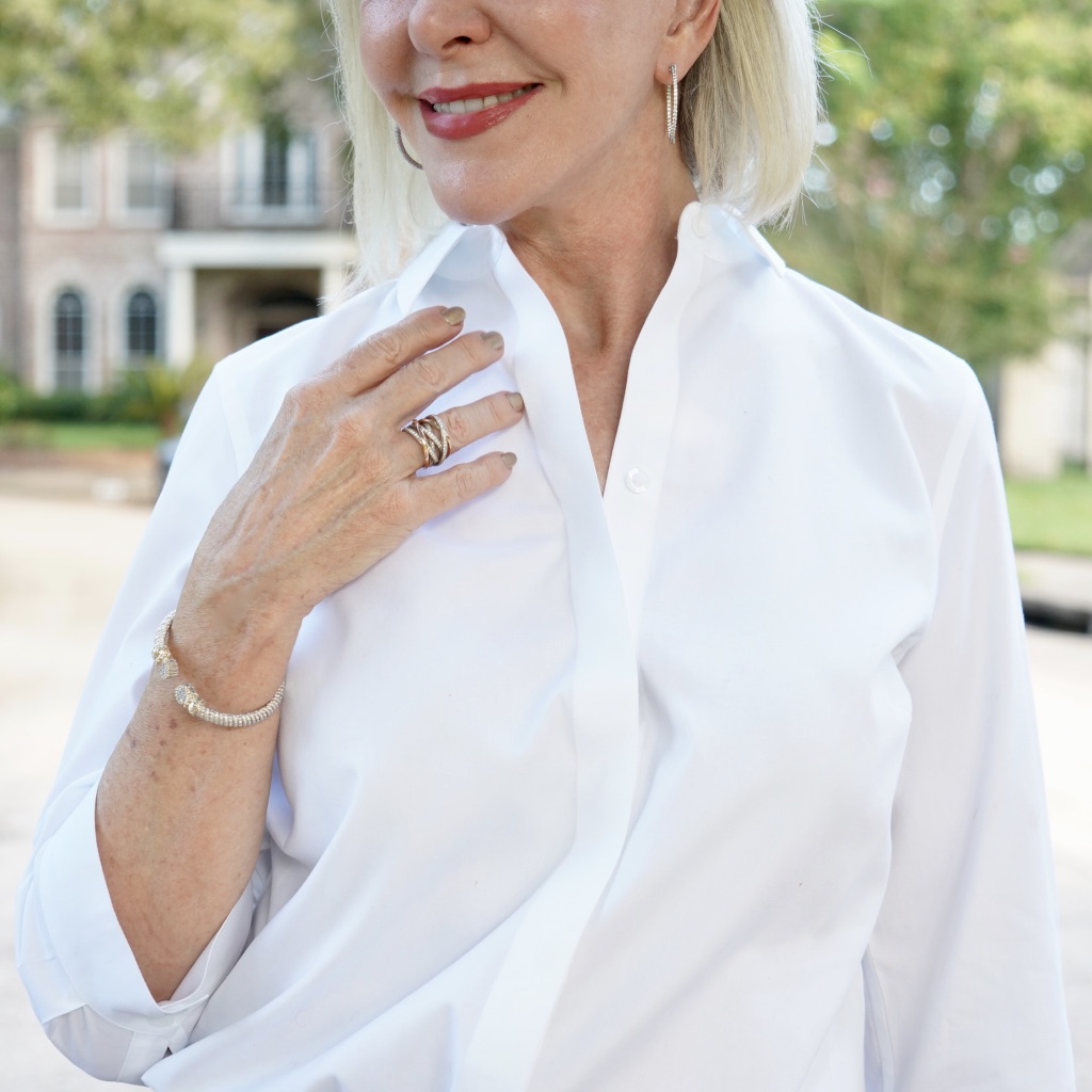 Up close photo of Sheree from SheShe Show with accessories wearing white top.