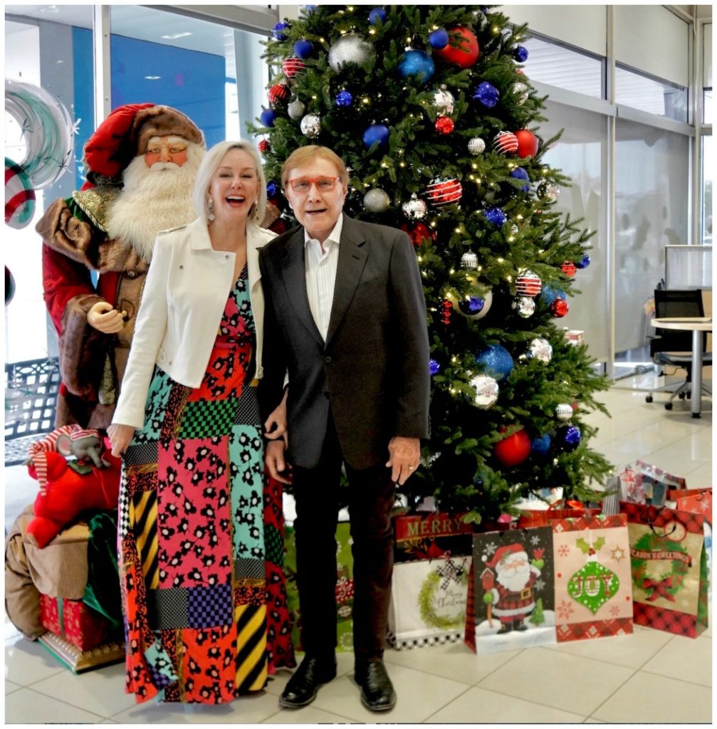 Sheree and Norman Frede standing together in front of Christmas tree