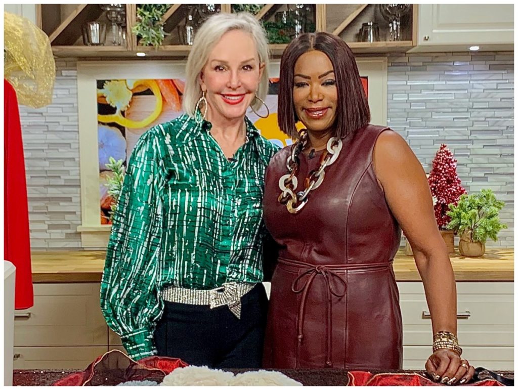 Sheree of the SheShe Show wearing green to with hostess Debra Duncan wearing burgundy leather dress