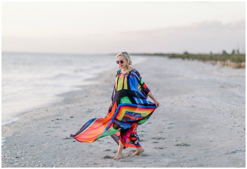 Sheree of the SheShe Show on the beach wearing an abstract multi colored  kaftan