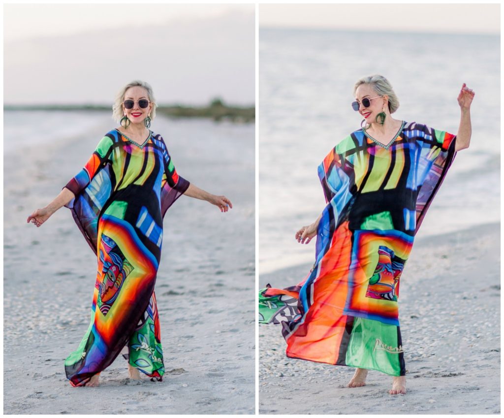 Sheree of the SheShe Show on the beach wearing an abstract multi colored kaftan