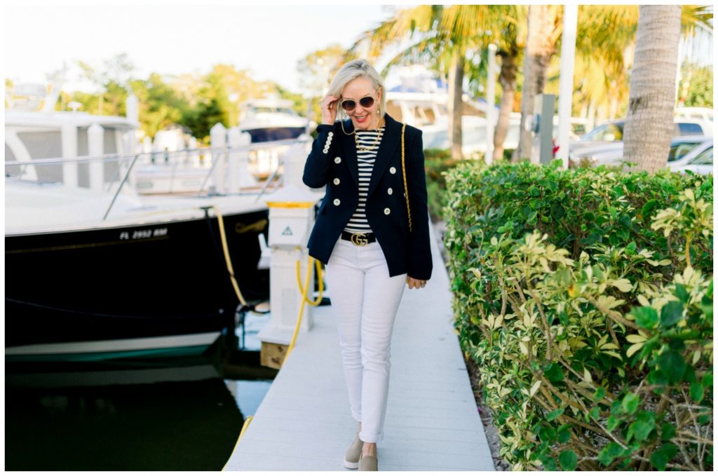 Sheree of the SheSheShow walking by marina wearing white jeans and navy double breasted blazer