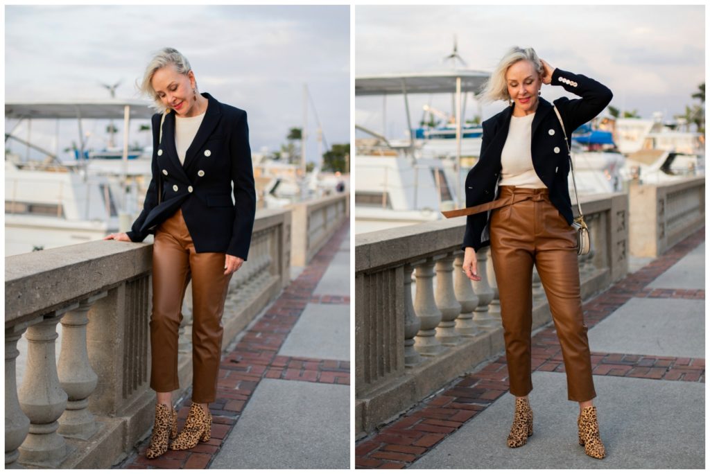 Sheree of the SheSheShow walking by marina wearing brown leather pants and navy double breasted blazer