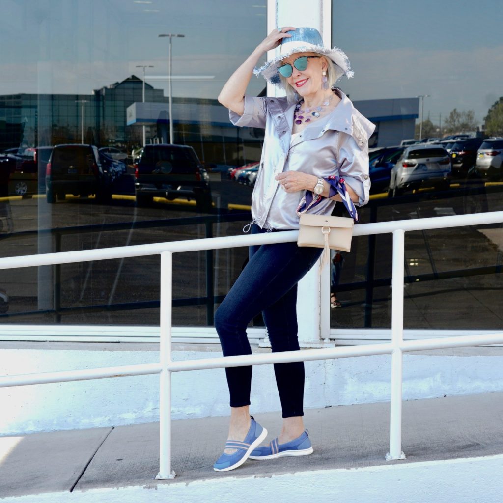 sheree frede wearing silver jacket, blue hat, jeans and easy spirit shoes