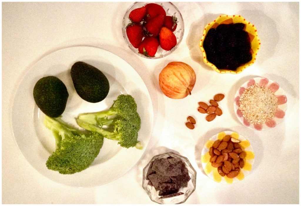 photo of brocalli, avocado, almonds, dark chocolate, berries and oatmeal
