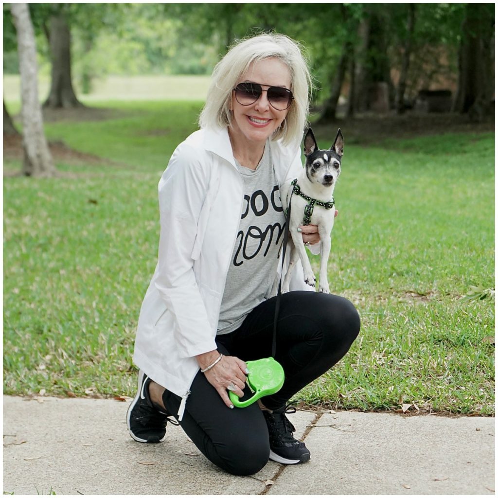 Sheree Frede of the SheShe Show outdoors exercising with her dog.