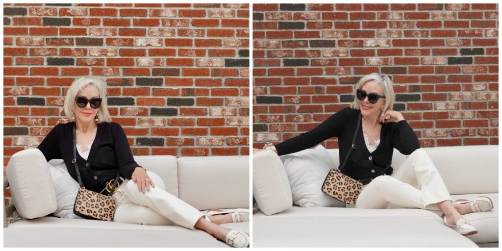 Sheree Frede of the SheShe Show sitting on a big offwhite sofa wearing off white jeans and black sweater.
