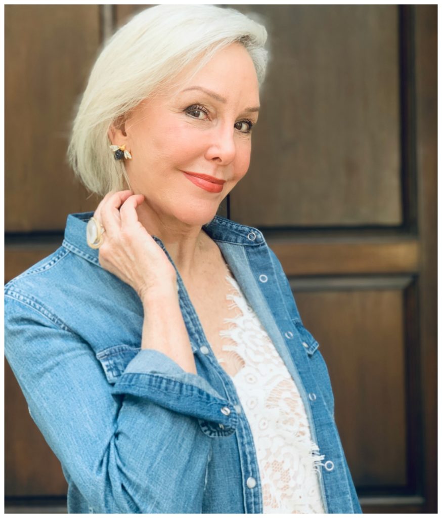 Sheree Frede of the SheShe Show wearing a denim shirt and showing bumble bee earrings