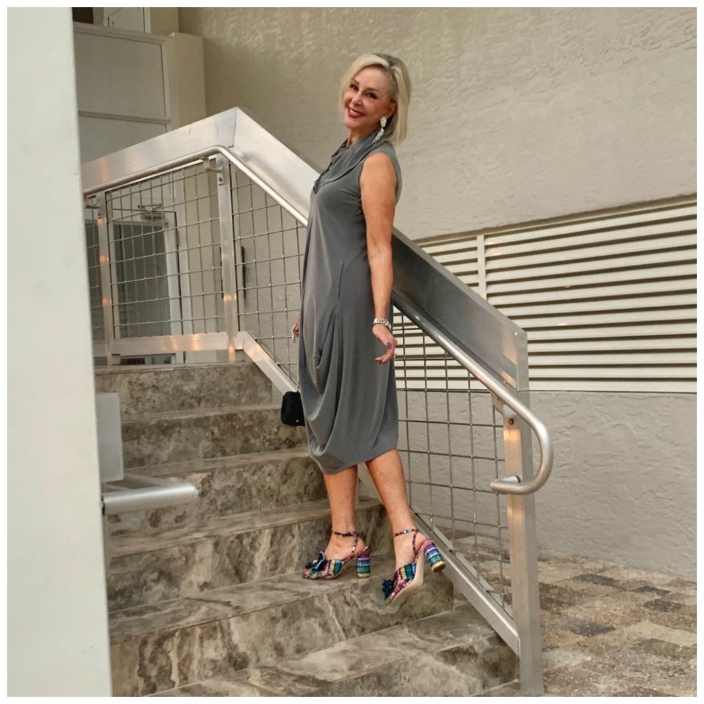 Sheree Frede going up stairs wearing a grey bubble dress