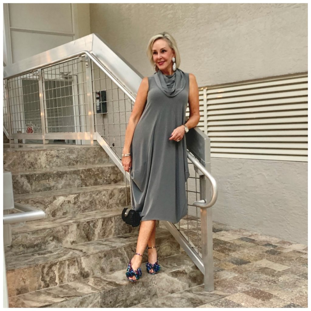 Sheree Frede going up stairs wearing a grey bubble dress