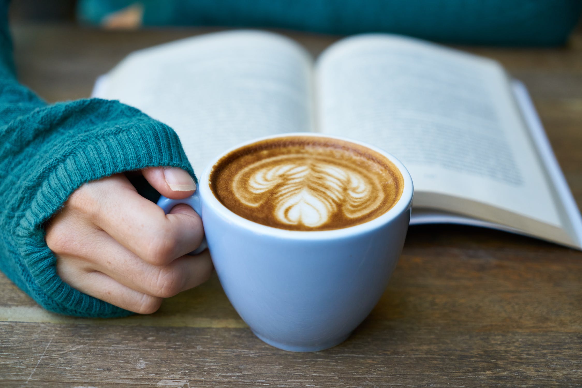 Open book with cup of coffee