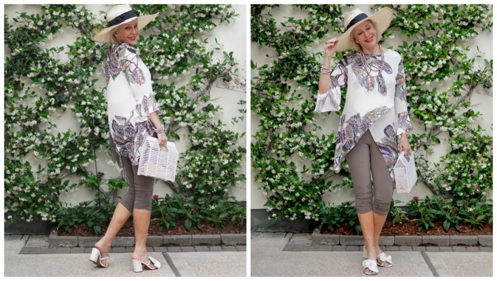 Sheree Frede of the SheShe Show standing in front of jasmine vine wall wearing print top over leggings