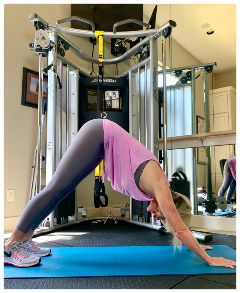 Sheree Frede of the SheShe Show in home gym wearing a pink tank over gray leggings