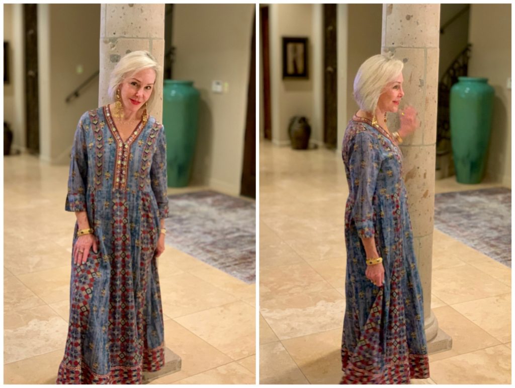 Sheree Frede of the SheShe Show standing in foyer by column wearing a chambray maxi dress accented in embellishments