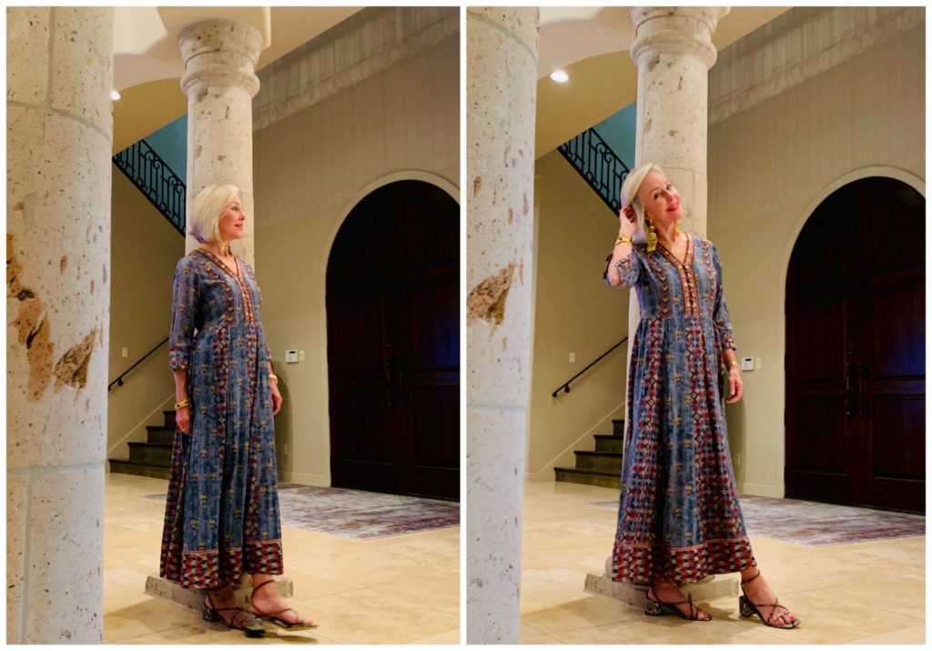 Sheree Frede of the SheShe Show standing in foyer by column wearing a chambray maxi dress accented in embellishments