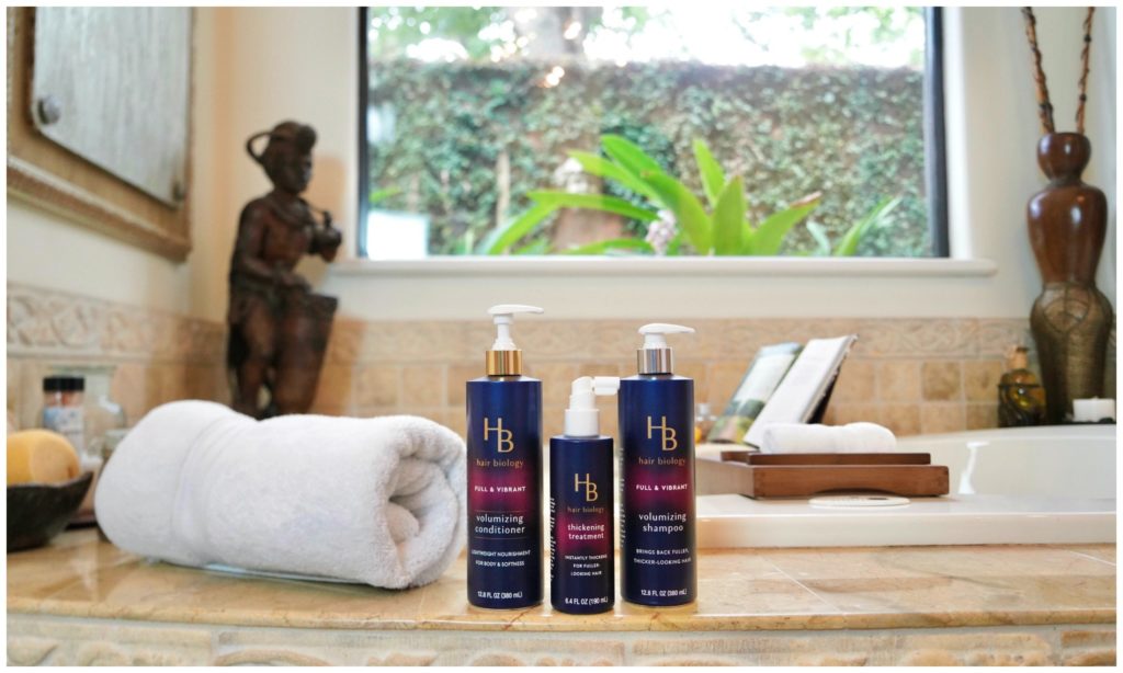 Hair biology 3 products sitting on bathtub ledge