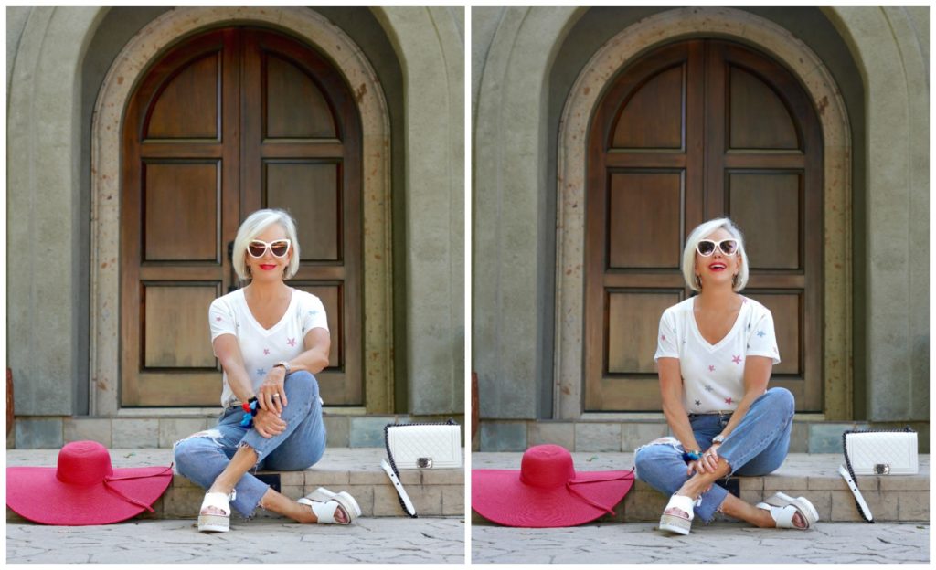 sheree of the SheSheShow sitting in front of house wearing ripped jeans and white star tee shirt