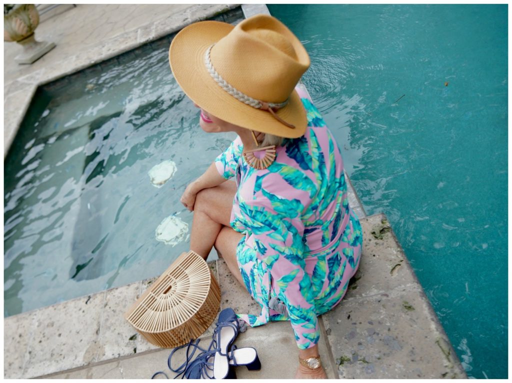 Sheree Frede of the SheShe Show wearing a tan hat by the pool