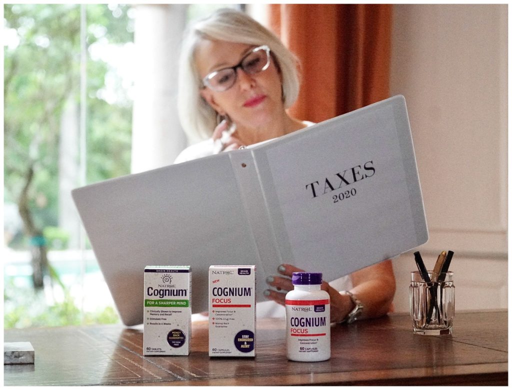 Sheree Frede of the SheShe Show sitting at desk reviewing taxes with Natrol Focus supplements