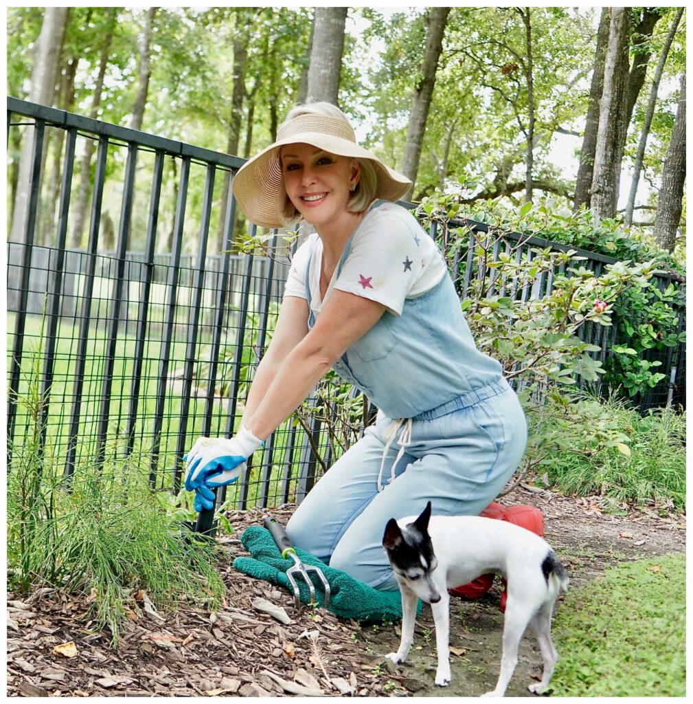 Sheree Frede of the SheShe Show sitting on knees planting her garden