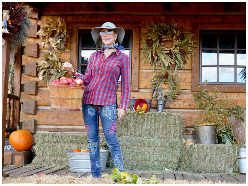 Sheree Frede of the SheShe SHow standing holding a basket of apples