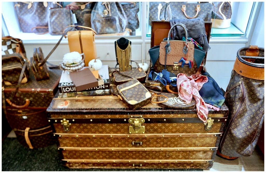 Display of pre-owned Louis Vuitton leather goods. Trunk, bags, etc.