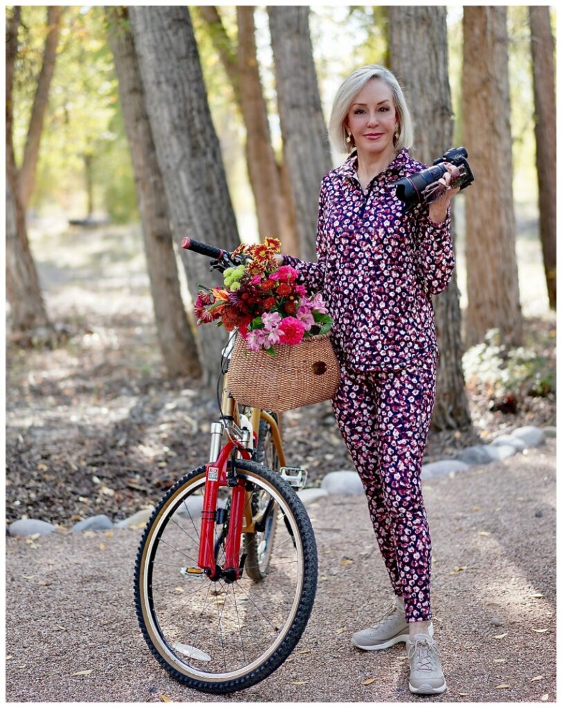 Sheree Frede of the SheShe Show riding a bike wearing a petite floral athleisure set