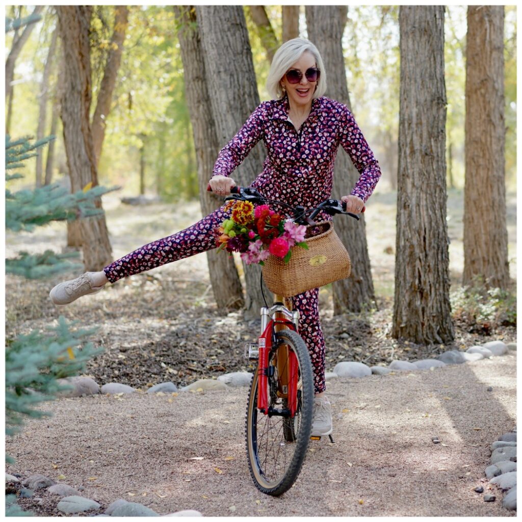 Sheree Frede of the SheShe Show riding a bike wearing a petite floral athleisure set