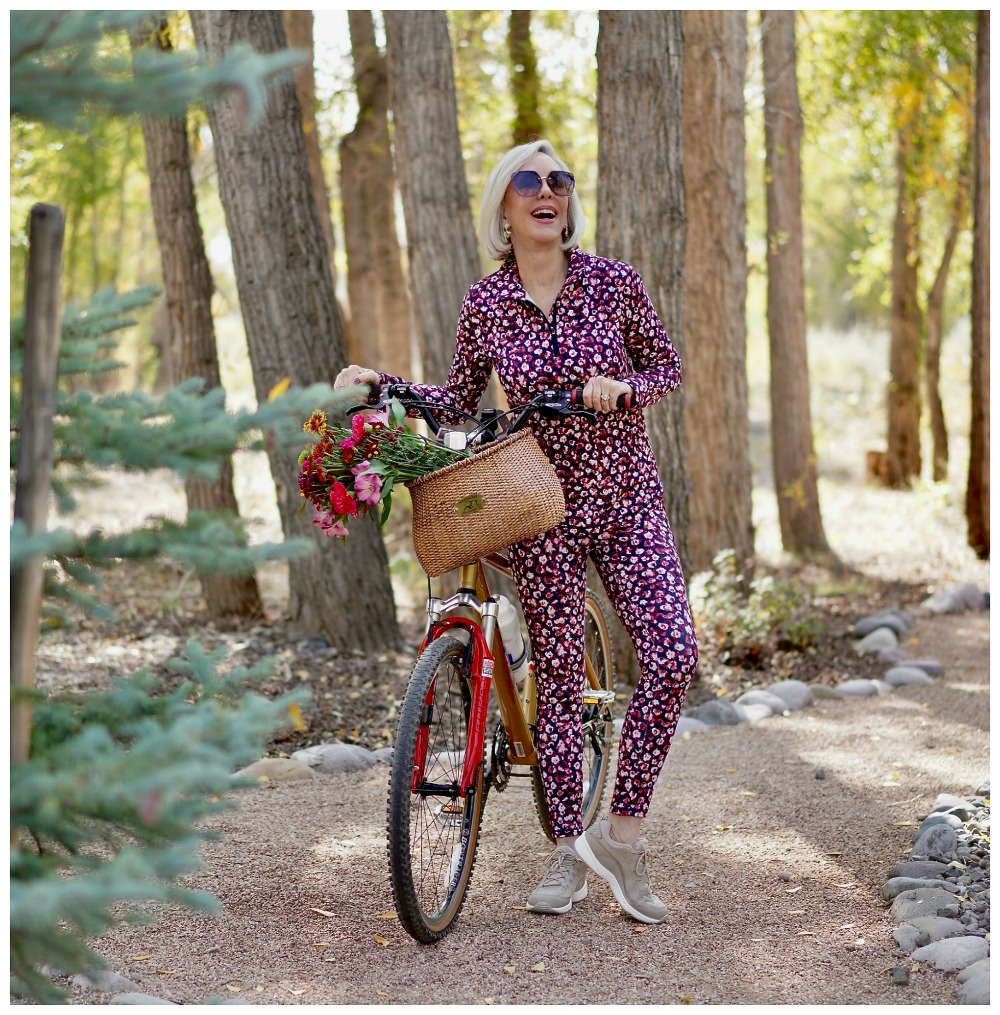 Sheree Frede of the SheShe Show riding a bike wearing a petite floral athleisure set