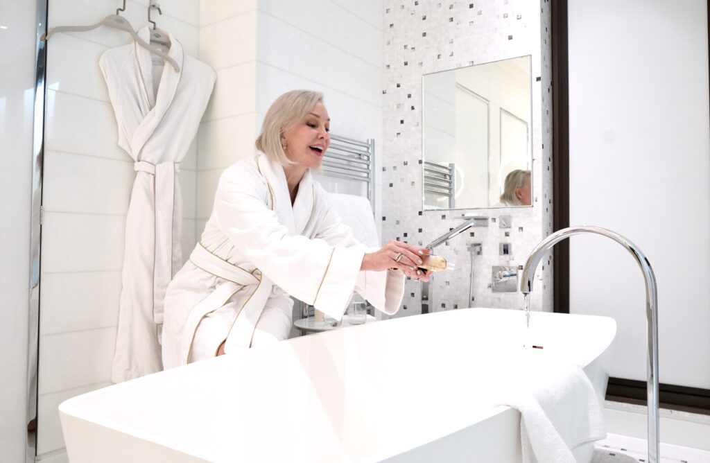 sheree frede pouring bubble bath into bathtub