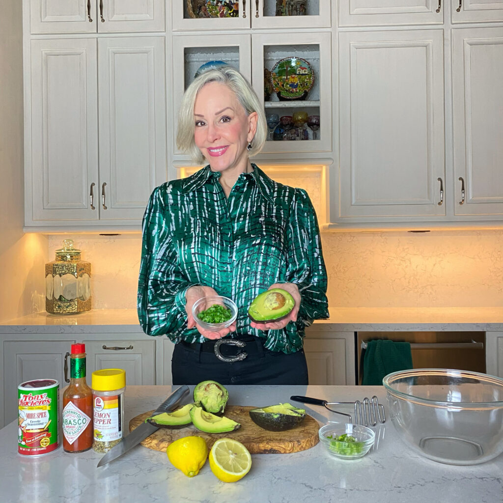 Sheree Frede of the SheShe Show in the kitchen making guacamole wearing a green print shirt