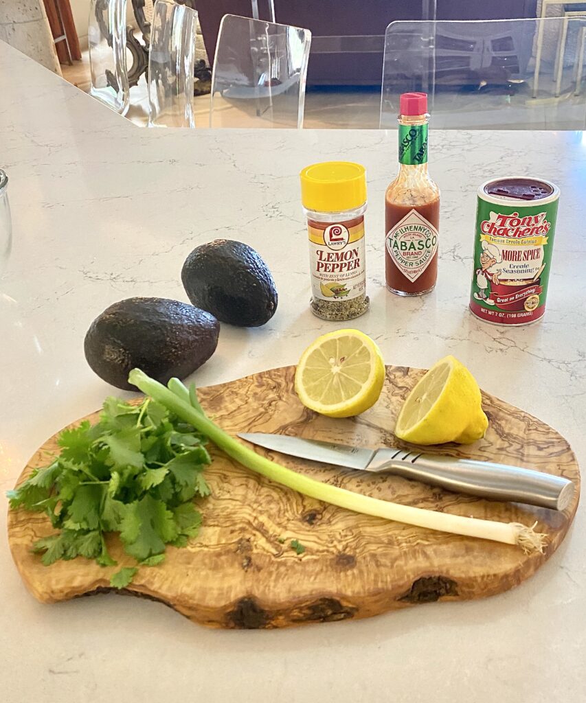 Sheree Frede of the SheShe Show in the kitchen making guacamole wearing a green print shirt