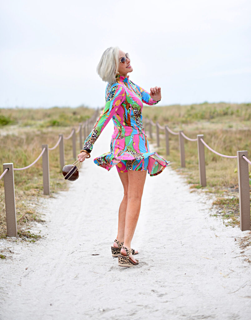 Sheree Frede of the SheSheShow multi-colored spf longsleeve top and skirt, big straw hat, coconut bag, leopard print sandals